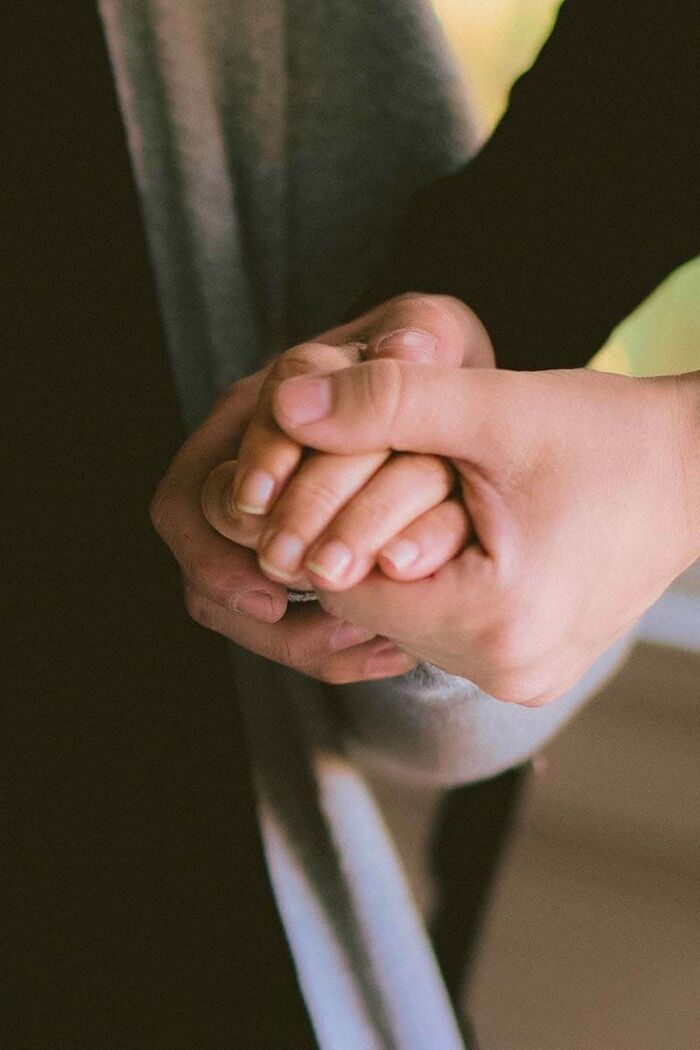 Two hands held together in comfort
